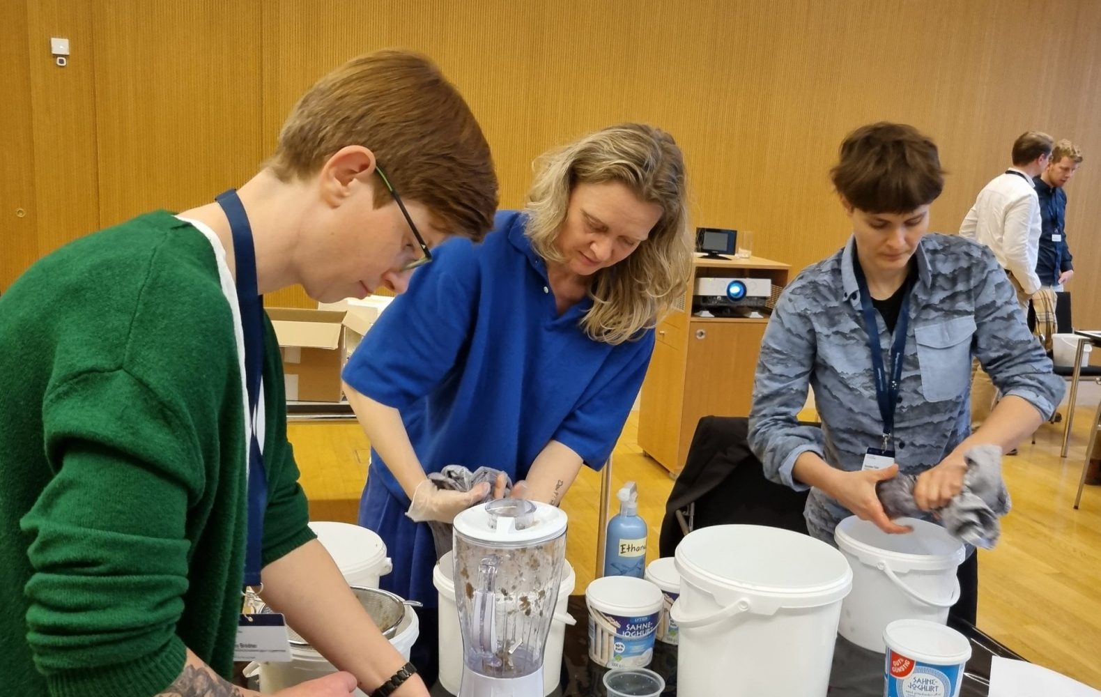 Drei Frauen arbeiten mit Handtüchern an einem Tisch