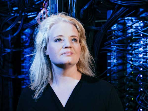 Portrait einer Frau, im Hintergrund bläulich schimmernde technische Elemente
