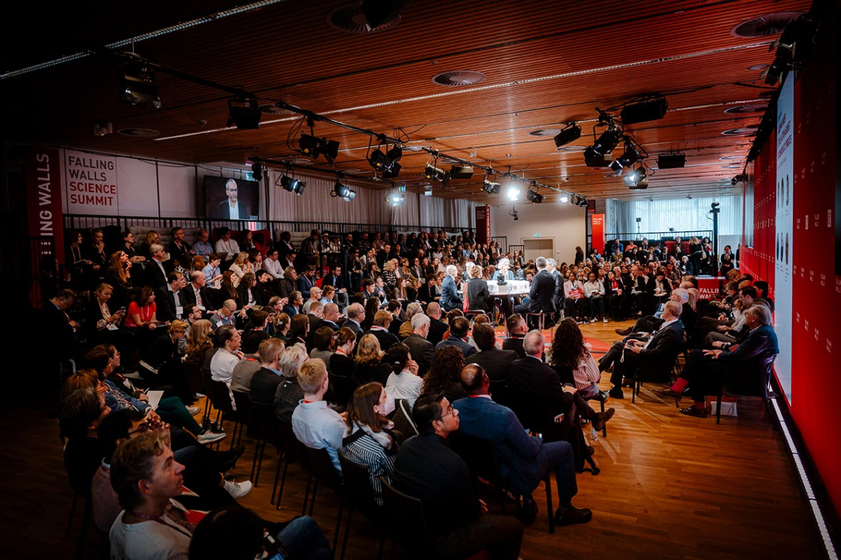 Personen in einem Plenum mit einem zentralen Tisch